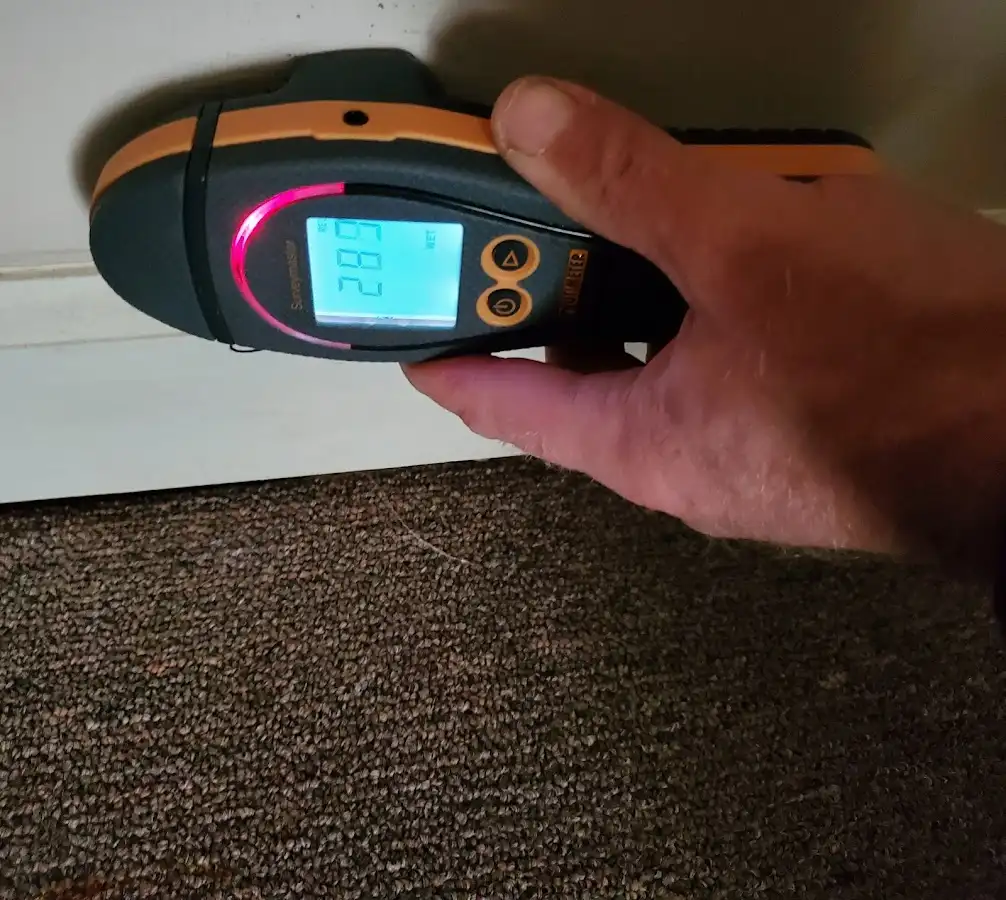 Moisture detection at baseboard during Storm Damage Restoration in Long View